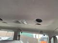 Interior view of a 2010 Ford Econoline ceiling showing lights air vents and fabric upholstery