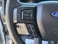 Steering wheel of a 2019 Ford F-150 featuring control buttons for settings and navigation
