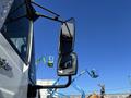 A 2013 International 7500 truck with two side mirrors prominently displayed in the foreground