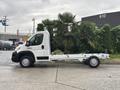 A white 2023 RAM Promaster 3500 chassis cab with a long wheelbase and no cargo bed visible is parked on a concrete surface