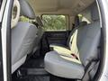 Interior of a 2013 RAM 5500 showing the rear seat area with gray fabric upholstery and seatbelts