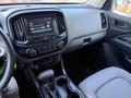 Interior of a 2018 GMC Canyon featuring a dashboard with a touchscreen display and controls on the center console