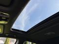 Sunroof opening in the ceiling of a 2024 Kia Forte5 with visible interior features