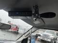 A 2006 Ford Econoline interior view showing a control panel mounted on the ceiling with various indicator lights and a handle for operation