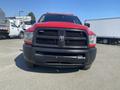 A red 2015 RAM 2500 truck viewed from the front featuring a black grille and bold headlights