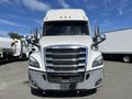 Front view of a 2022 Freightliner Cascadia with a white exterior and chrome accents on the grille and bumpers