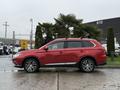 A red 2016 Mitsubishi Outlander parked with its profile visible showcasing its sleek design and alloy wheels
