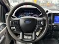 Steering wheel of a 2020 Ford F-550 with control buttons and the Ford logo in the center
