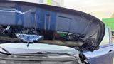 The image shows the underside of the hood of a 2019 Nissan Kicks with various mechanical components visible