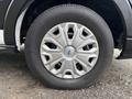 A wheel of a 2020 Ford Transit 250 featuring a silver hubcap with a geometric design and a thick black tire