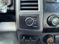 Dashboard controls of a 2020 Ford F-550 featuring a dial for selecting 2H 4H and 4L drive modes along with additional audio controls