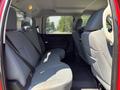 Interior view of the back seat of a 2013 RAM 2500 with grey fabric upholstery and seat belts visible