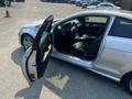 A 2013 Mercedes-Benz C-Class with the driver's side door open showcasing a sleek black interior and dashboard