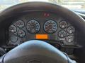 Dashboard of a 2009 International 3000 CE showing various gauges for speed, engine temperature, fuel level, and other metrics with a central digital display