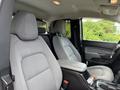 A 2017 Chevrolet Colorado with gray fabric seats and a center console seen from the front passenger side