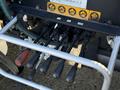 Control levers of a 2015 Hino 358 truck with several color-coded indicators for operational functions and a metal frame supporting the levers