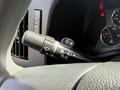 A close-up of the turn signal and wiper control stalk in a 2020 Chevrolet Express dashboard with various control symbols visible