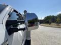 A 2017 Ford F-550 with a chrome side mirror reflecting surrounding objects