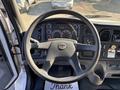 Dashboard and steering wheel of a 2006 Freightliner M2 106 with various gauges and controls visible