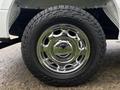 A chrome wheel rim with multiple cutouts mounted on a large all-terrain tire displaying the Falken brand logo