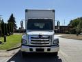 A white 2020 Hino 268 truck with a large cargo box and chrome grille facing directly towards the viewer