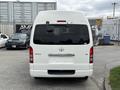 A 2009 Toyota Hiace van viewed from the rear with a white exterior and no visible license plate