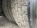 Close-up of a worn tire from a 2013 International Workstar 7500 showing visible tread patterns and a dirty surface