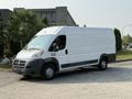A 2017 RAM Promaster van with a white exterior and a gray bottom, featuring large wheels and a spacious cargo area visible from the side
