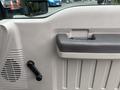 Interior detail of a 2010 Ford F-550 Super Duty door showing the handle and window crank