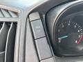 Close-up of the dashboard controls of a 2018 Ford Transit-350 featuring a button labeled TCS OFF and a speedometer indicating speed