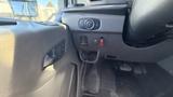 Interior view of a 2021 Ford Transit showing the dashboard controls and a portion of the driver seat