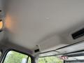 Interior view of a 2021 Freightliner M2 106 cab ceiling featuring a smooth gray surface with overhead lights and ventilation controls