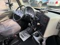 Interior of a 2013 International Durastar 4300 featuring a driver seat dashboard controls and gear shifter with various gauges and a radio