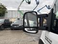 2023 RAM Promaster 3500 white van with a large side mirror reflecting nearby vehicles and showing rain droplets on the surface