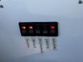 Control panel with four switches labeled for traffic strobe generator bucket and master functions