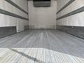 Interior view of a 2018 Hino 195 truck with a spacious cargo area featuring gray wooden flooring and metal side rails