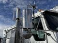 A 2008 Kenworth T370 featuring a chrome side mirror and exhaust stack with a polished finish