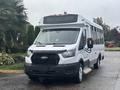 2021 Ford Transit-350 with a white exterior and large windows designed for passenger transport featuring a black grille and front bumper
