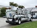 A 2006 Sterling L7500 vacuum truck with a large tank and hose attachments on the rear for suction and waste collection