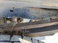 Close-up view of the undercarriage of a 2016 Ford F-250 Super Duty showcasing the frame and suspension components