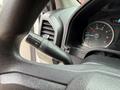 Close-up view of the steering column of a 2018 Ford F-150 featuring a gear shift lever and instrument cluster with speedometer and RPM gauge