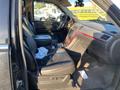Interior view of a 2007 Cadillac Escalade showing two front seats with black leather upholstery and a central console
