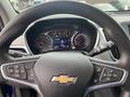 Steering wheel of a 2022 Chevrolet Equinox with controls and a dashboard display showing speed and indicators