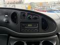 Dashboard of a 2008 Ford Econoline featuring air conditioning controls a radio and multiple air vents