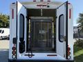 White 2016 Ford Econoline with open rear doors revealing a wheelchair lift inside