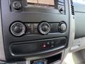 The dashboard controls of a 2016 Mercedes-Benz Sprinter featuring knobs for climate control and an audio system display