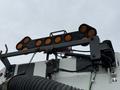 A 2009 UD Trucks UD 3300 featuring multiple orange lights mounted on a bracket above the cab with a chain and attached hoses visible on the truck
