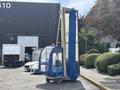 A 2023 Bitimec SC415 street cleaning vehicle with a blue brush attachment and a transparent enclosure for the operator is parked in a lot