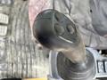 Close-up of a control joystick from a 2018 John Deere 350 construction machine showing three buttons on top and a textured grip