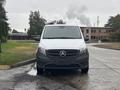 A 2021 Mercedes-Benz Metris van with a silver front grille and a black bottom section is parked facing the viewer